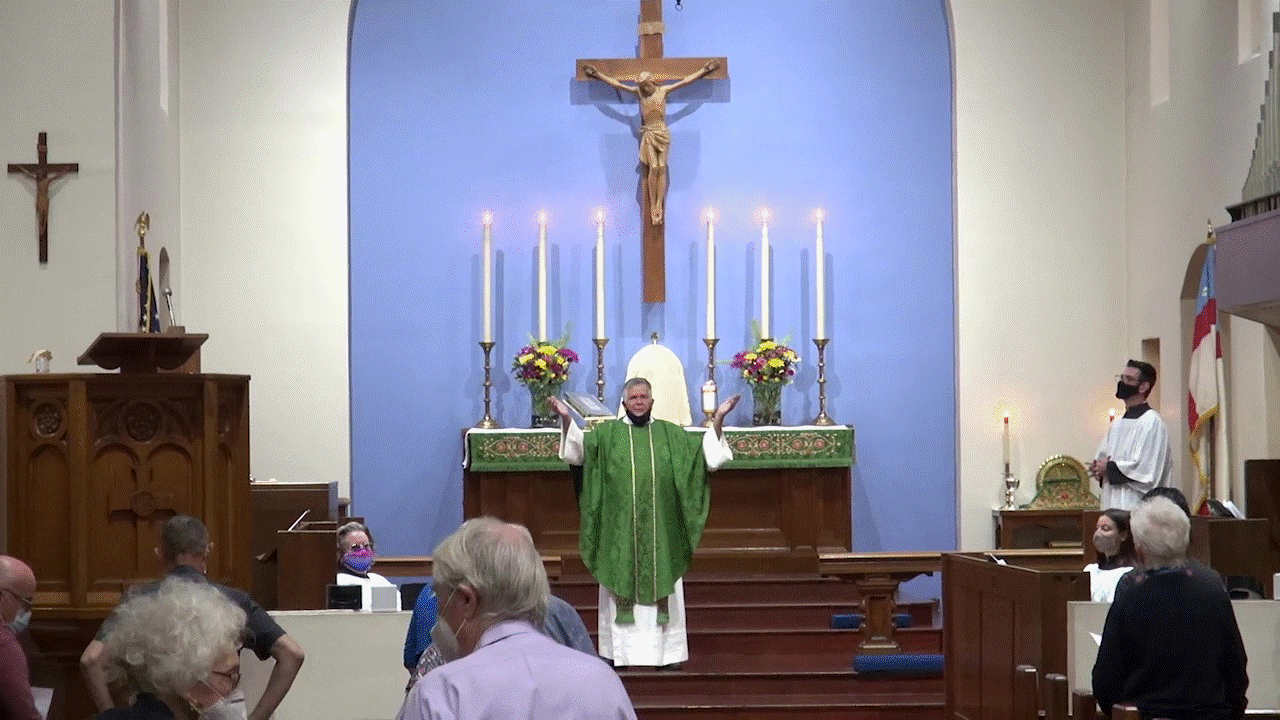 Father Carlos preaching at our courtyard Mass